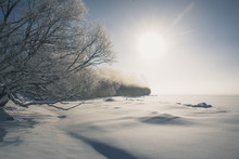 Scenic View Of Snow Covered Landscape Against Sky During Sunny Day