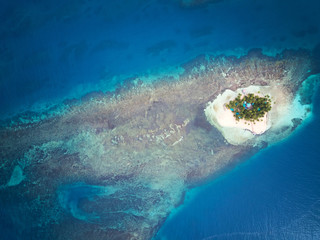 Poster - Small island around blue sea water