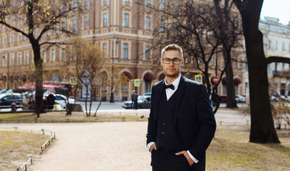 Portrait of a young businessman or groom over blurred background indoors