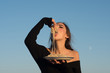 © Volodymyr - Young beautiful woman eating spaghetti, on blue sky background