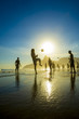 Brazil kick-ups sunset silhouettes playing altinho futebol beach football with soccer ball Ipanema Beach Rio de Janeiro