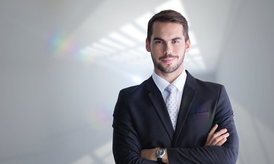 Sticker - Smiling businessman posing with arms crossed against room with windows at ceiling