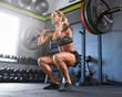 © Erik Valind - Woman doing barbell squat in the gym