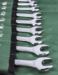 Open-end wrench set on green cover.