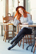 © danissimo1992 - Stylish young beautiful smiling red-haired girl in a burgundy hat in a street cafe