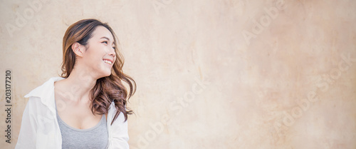 Portrait Of Young Beautiful Asian Woman Sit With Her Finger Point