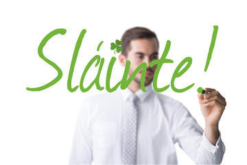 Poster - Cheerful businessman writing with marker against shamrock