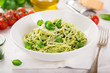 © anna_shepulova - spaghetti pasta with basil pesto sauce and parmesan cheese on white bowl