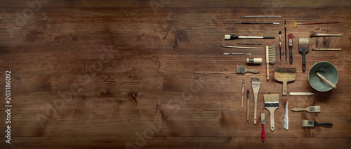 Fotomural painting still life with lot of type brushes and other tools on a wooden backgro