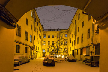 Poster - urban courtyard in St Petersburg in night snowfall