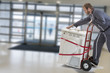 © JPC-PROD - Delivery man pushing hand truck washing machine home appliance