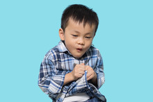 Asian Boy Pretend To Be Scared And Acts Like Afraid But Makes Funny Face, Blue Background