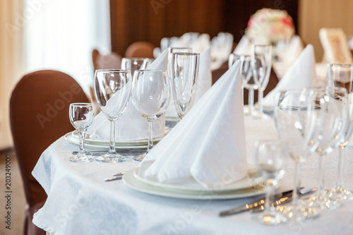 Glasses Flowers Fork Knife Napkin Folded In A Pyramid Served