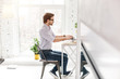 © zinkevych - Occupational. Determined bearded man sitting at the table and working on his laptop