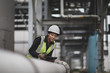 © ReeldealHD images - Female industrial worker checking pipeline