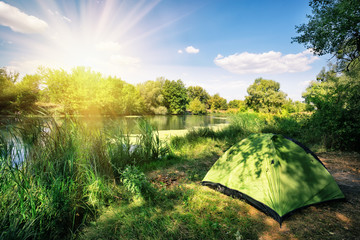 Wall Mural - green tourist tent on the river bank