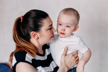 Crying toddler girl being consoled by her mother