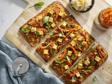 Overhead View Of Kimchi Pizza On Cutting Board