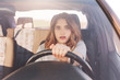 © sementsova321 - Terrified young cute female looks with depressed scared expression in front as drives car, has collision with other transport or accident on road, being inexperienced driver. Problems on road