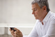 © Erickson Stock - Businessman using his ipone.