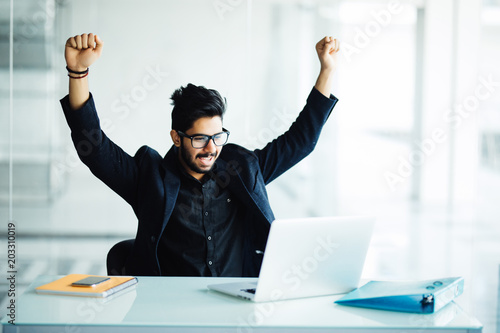 Indian Young Bearded Businessman With Hands Stretched Pose While Working On Laptop Celebrating Victory In Office Stock Photo Adobe Stock Indian Young Bearded Businessman With Hands Stretched Pose While Working On Laptop Celebrating Victory In Office Stock Photo Adobe Stock