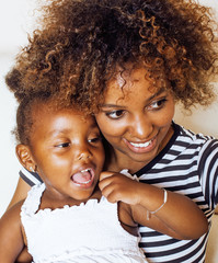 adorable sweet young afro-american mother with cute little daugh