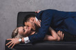 © LIGHTFIELD STUDIOS - side view of sexy young couple kissing on couch