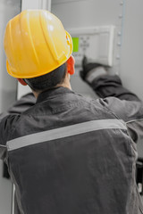 Wall Mural - engineer commissioning bay control unit. engineering department