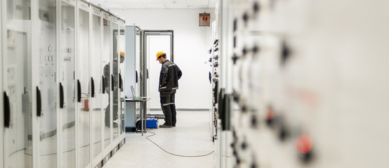 Wall Mural - engineer commissioning bay control unit. engineering department