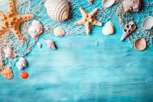 Summer Time Concept With Seashells And Starfish On Blue Wooden Boards. Rest On The Beach. Background With Copy Space