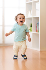 Wall Mural - Little baby boy running and laughing in ther living room