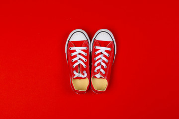 Wall Mural - Red sneakers top view close up on colorful background