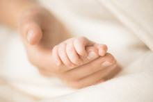Female Hand Holding Her Newborn Baby's Hand. Mom With Her Child. Maternity, Family, Birth Concept. Copy Space For Your Text