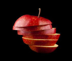 cut red apple on a black background