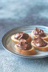 Wall Mural - Slice of baguette with chocolate cream on the saucer