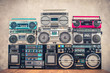 Retro old school design ghetto blaster stereo radio cassette tape recorders boombox tower from circa 1980s front concrete wall background. Vintage instagram style filtered photo