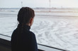 © olgasparrow - Child girl at the airport near the window looking at the plane and waiting for the flight time