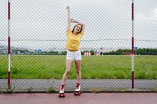 Young Girl In Roller Skates On Sports Ground