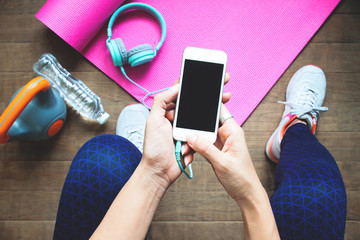 high angle view of sporty woman with fitness equipment using smartphone, diet and fitness, healthy l