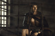 The muscular man in Roman armor. gladiator in armour. concept of masculinity, determination, strength