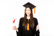 Beautiful Attractive Asian graduated woman in cap and gown smile with certificated in her hand and showing thumbs up feeling proud and happiness,Isolated on white background,Education Success Concept