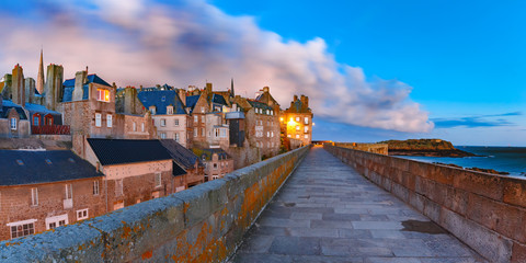 Wall Mural - Night panoramic view of beautiful walled city Intra-Muros in Saint-Malo, also known as city corsaire, Brittany, France