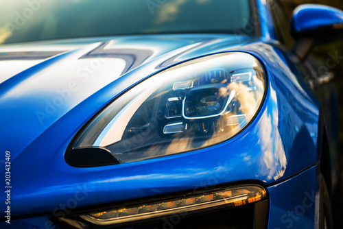 Cuadros en Lienzo luxury blue car front view. sunlight