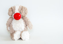 Red Nose Day-cuddly Stuffed Brown Bear Wearing A Red Nose Isolated On A Solid Background