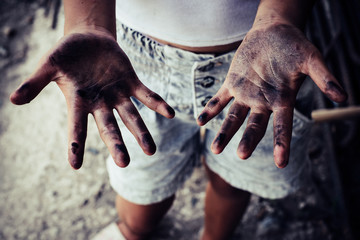 Dirty hands of children from construction work. World Day Against Child Labour concept.