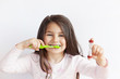 © kaganskaya115 - Little cute child girl brushing her teeth on white background. Space for text. Healthy teeth.