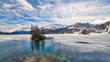 © michelangeloop - Engadine Valley. Spring thaw with islet on the lake