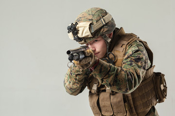 Wall Mural - Soldier in camouflage holding rifle