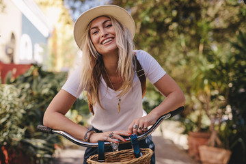 Beautiful woman with her bicycle outdoors