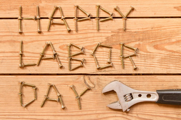 Wall Mural - Labor day.  Adjustable wrench on wooden background . The concept of labour